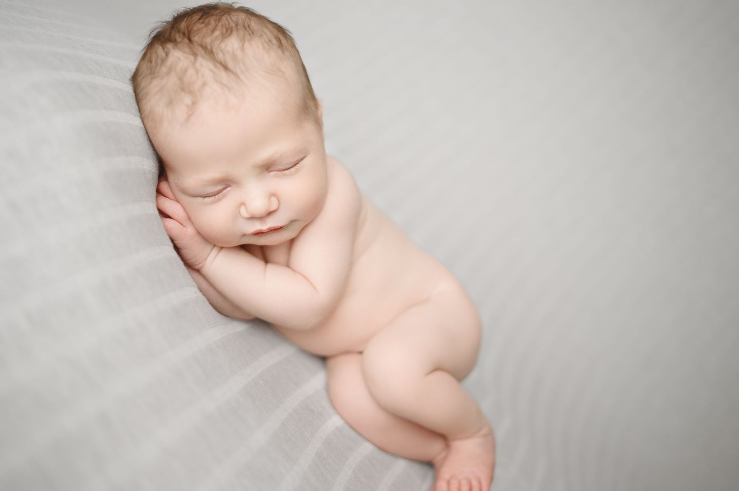 Artistic black and white portrait series of sleeping newborn in minimalist style.