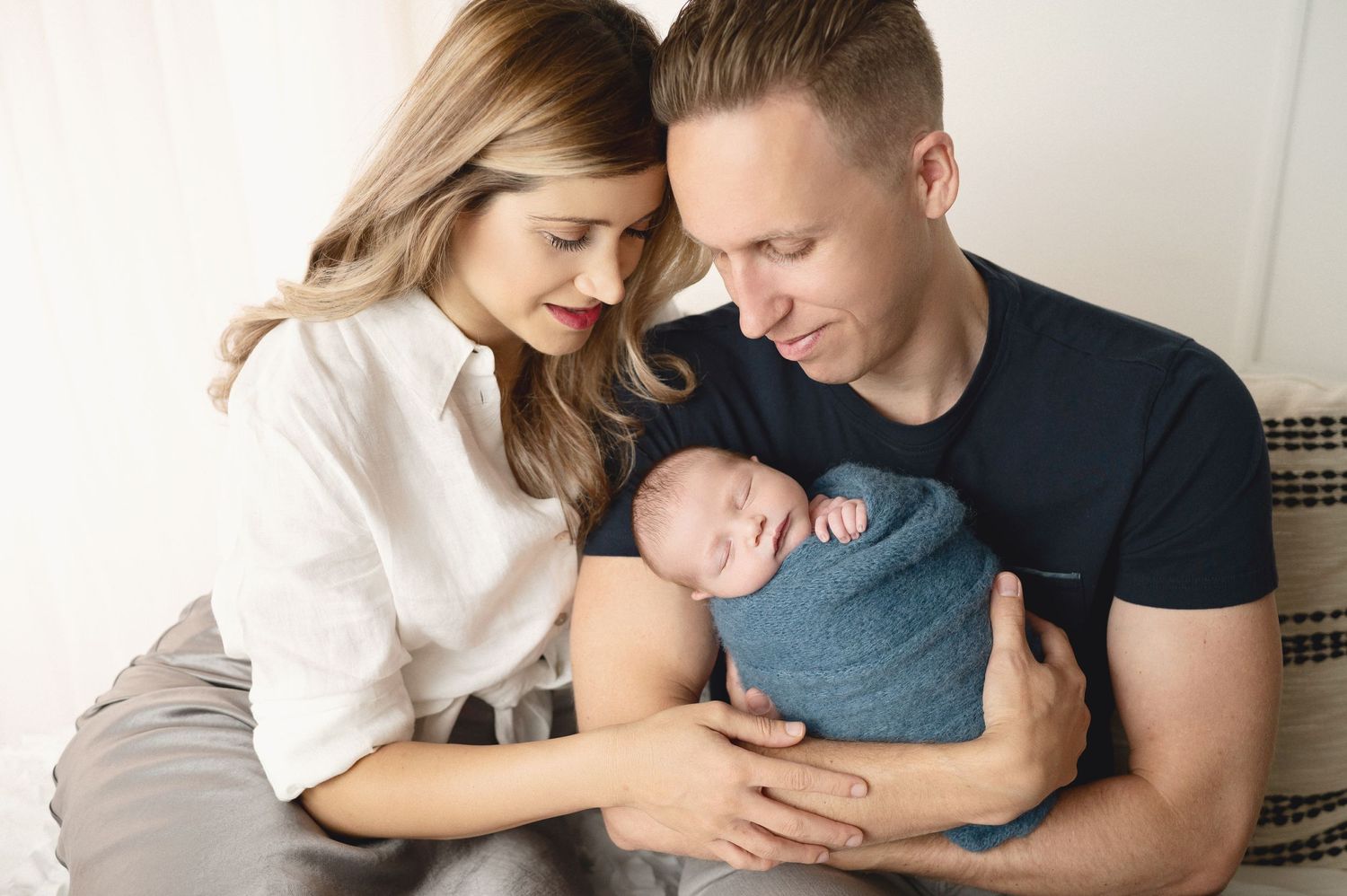 Intimate family photography session with soft neutral colors.