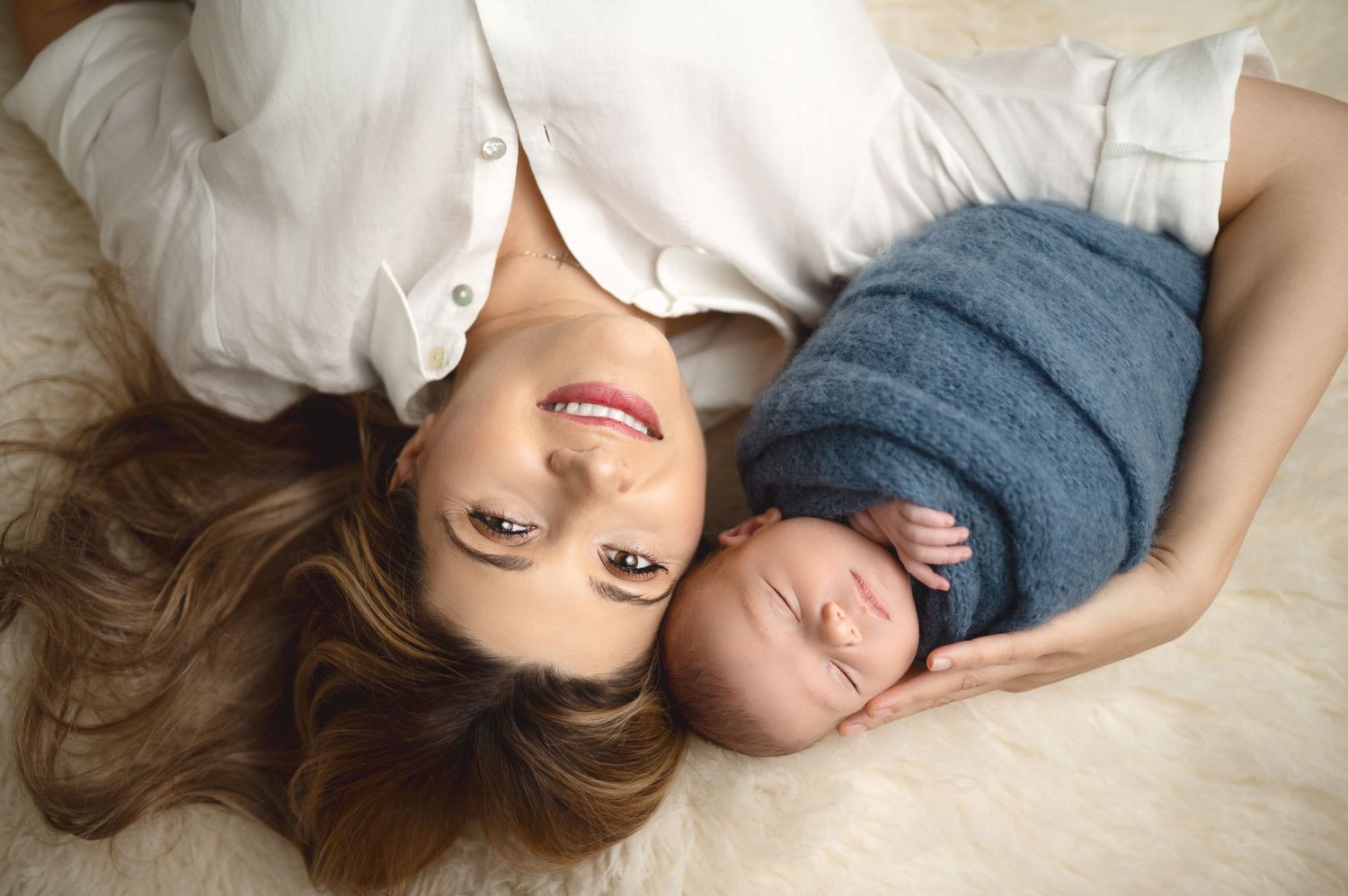 Family maternity photos with laying down poses on white background.