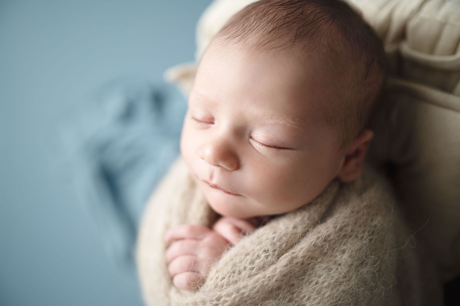 Sweet newborn sleeping portraits with blue tones and natural light.