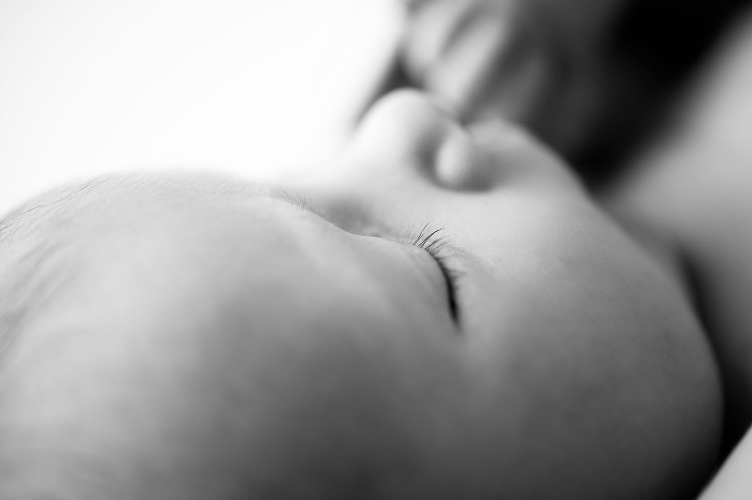 Artistic black and white macro shots of newborn features.