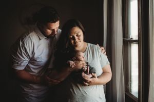 New family photo featuring their newborn baby - natural light photographer in Dickinson, ND