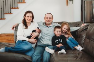 New large family welcomes newborn during lifestyle photography session at their home - lifestyle photographer in South Heart, North Dakota