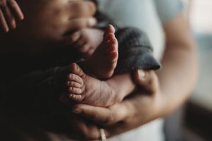Close-up of newborn feet during an in-home lifestyle photography session in Dickinson, North Dakota