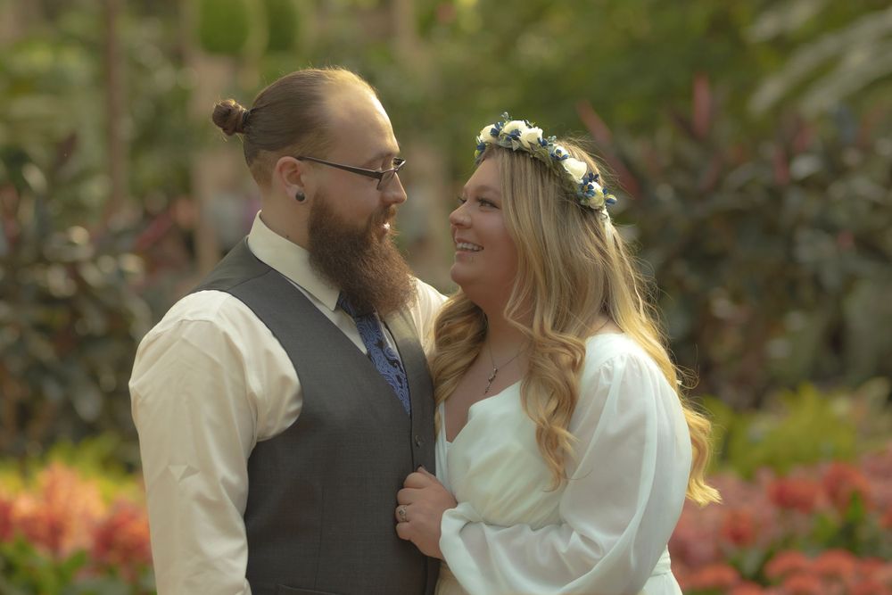Intimate portrait of a couple sharing a moment in a garden setting.