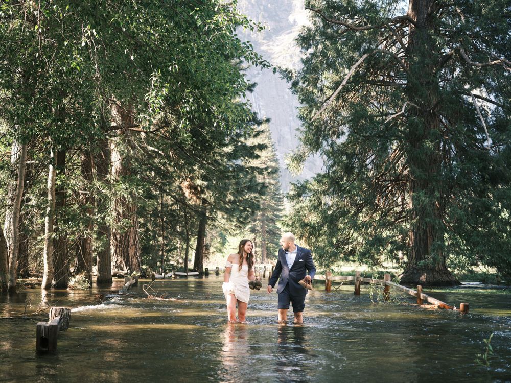 Bride and Groom walking through flooded Yosemite Valley for Wedding