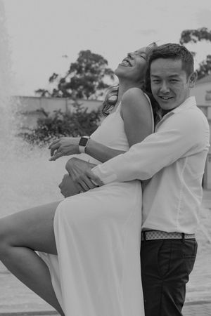 Black and white candid moment showing joy and laughter outdoors.