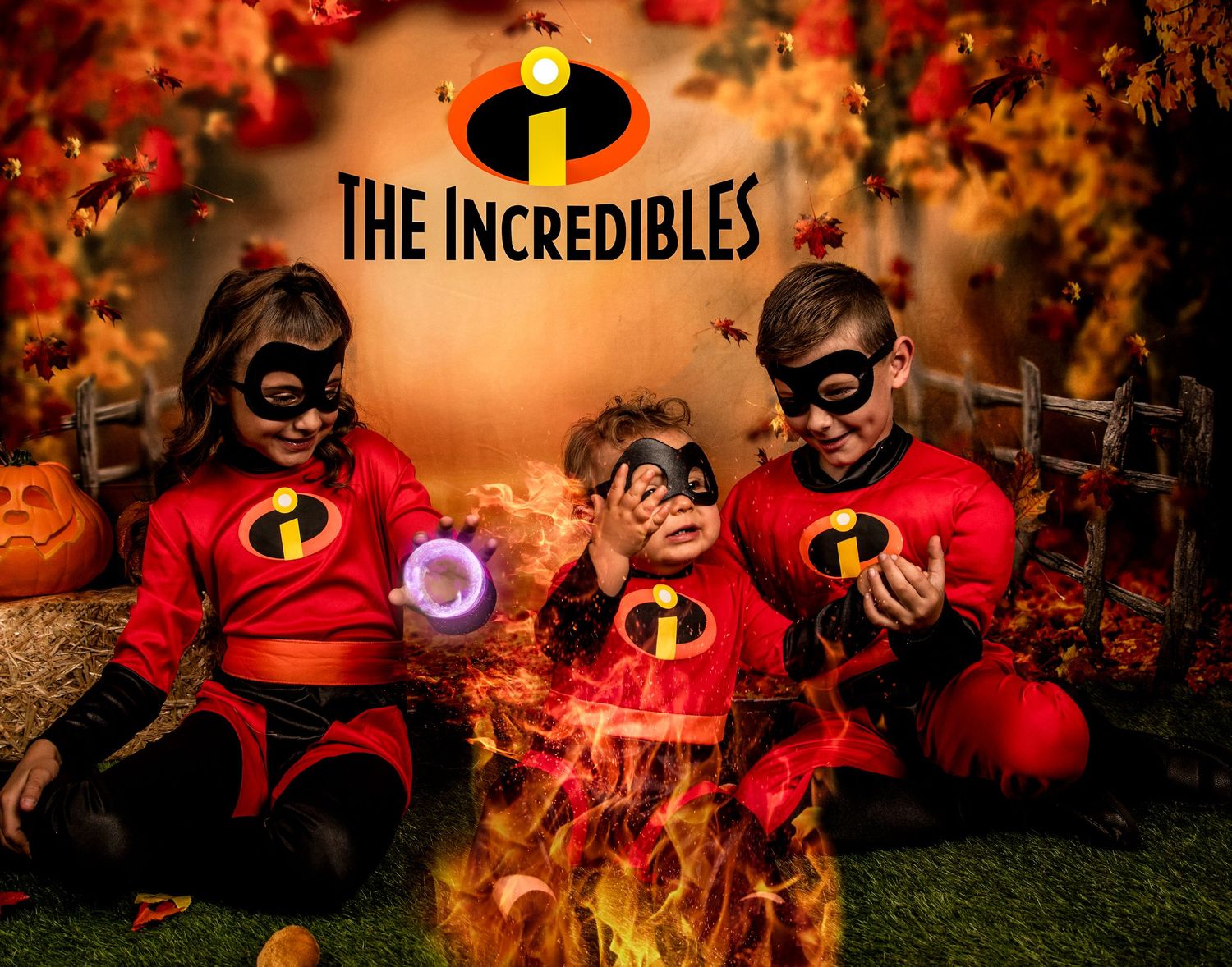 Three figures in red Incredibles costumes pose together in a Halloween setting with fall foliage.