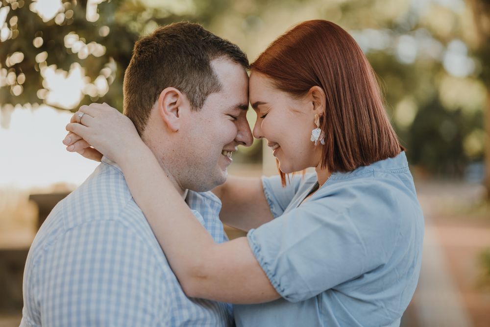 Intimate moment between couple wearing matching light blue outfits as they embrace.