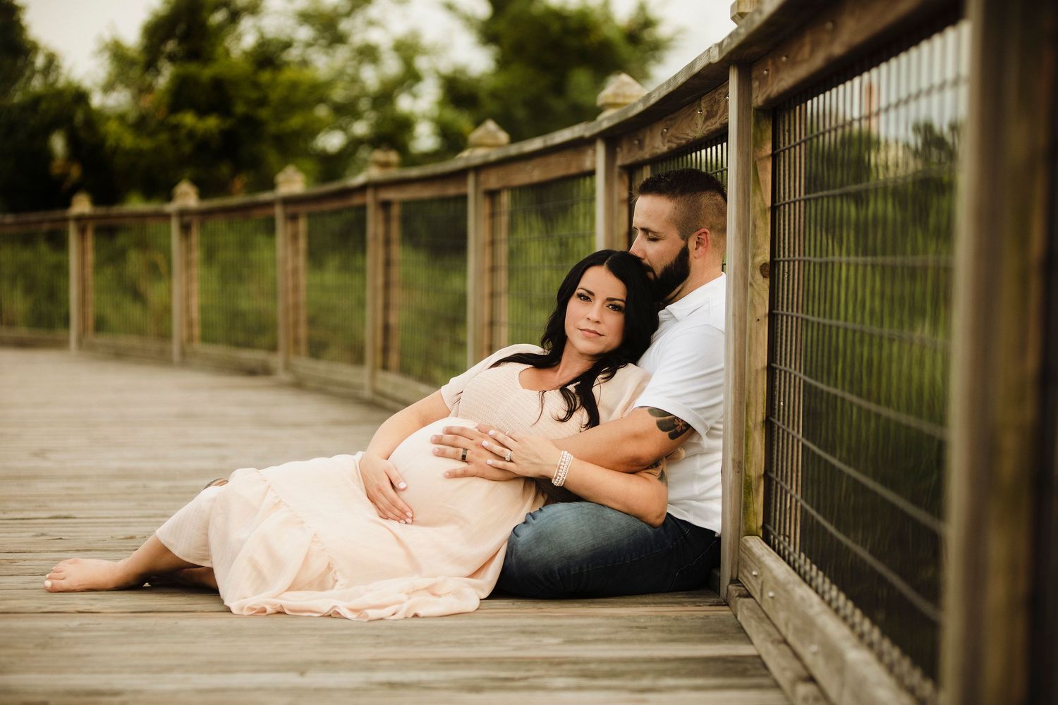 Outdoor couple maternity portrait photo.