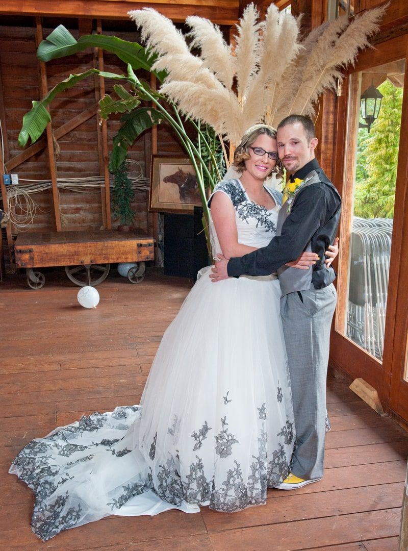 bride standing with flower headdress and groom holding each other formals during wedding in Graham, WA