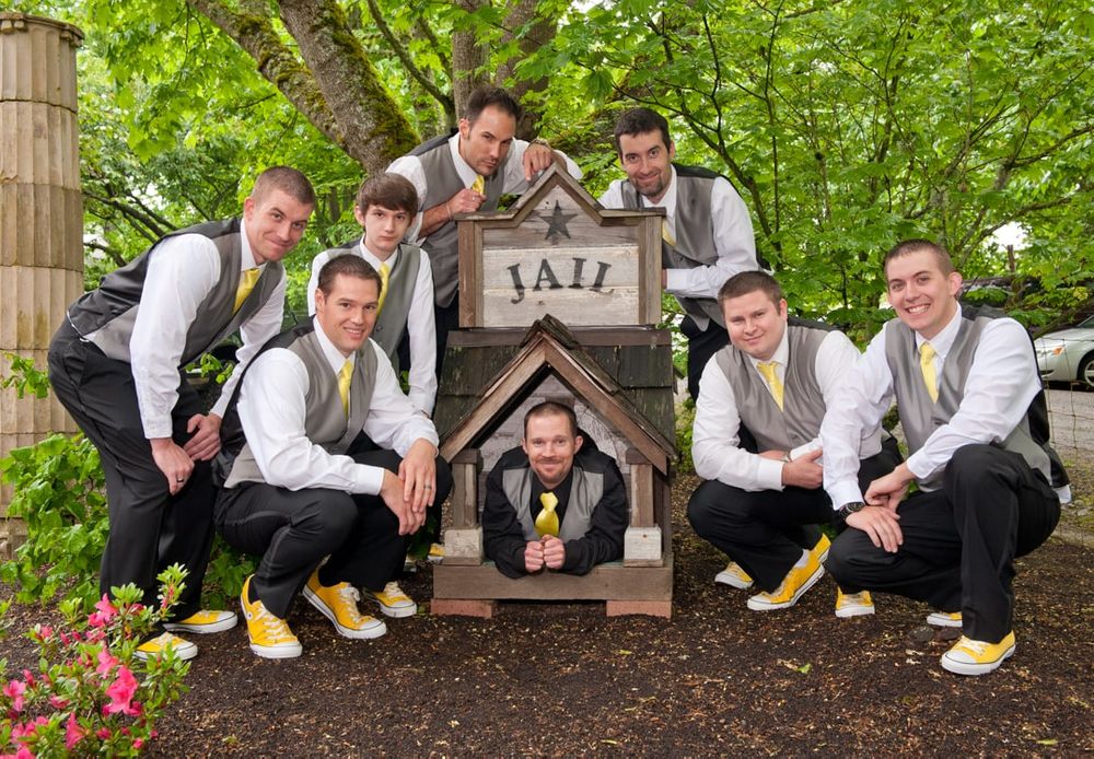 groom in a doghouse surrounded by groomsmen during wedding formals in Graham, WA