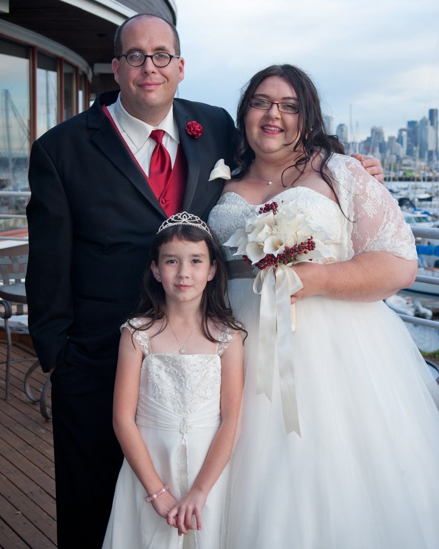 bride and groom with daughter wedding formals at palisades restaurant in seattle