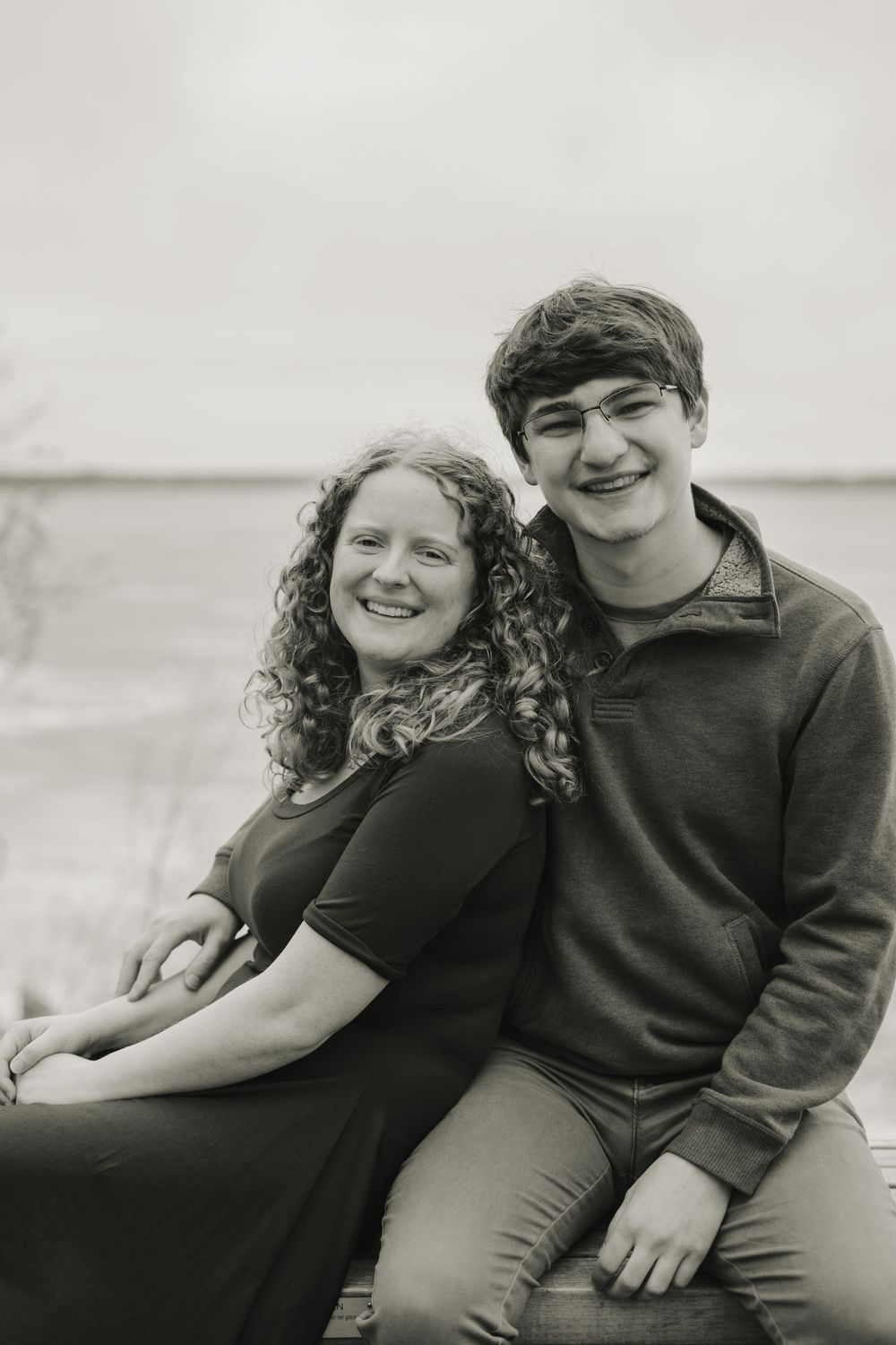 jake and emily leaning against each other with lake mendota in the background - couple photography in madison wisconsin