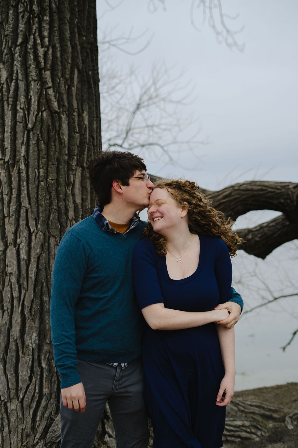 jake kissing emily's forehead - couple photography in madison wisconsin