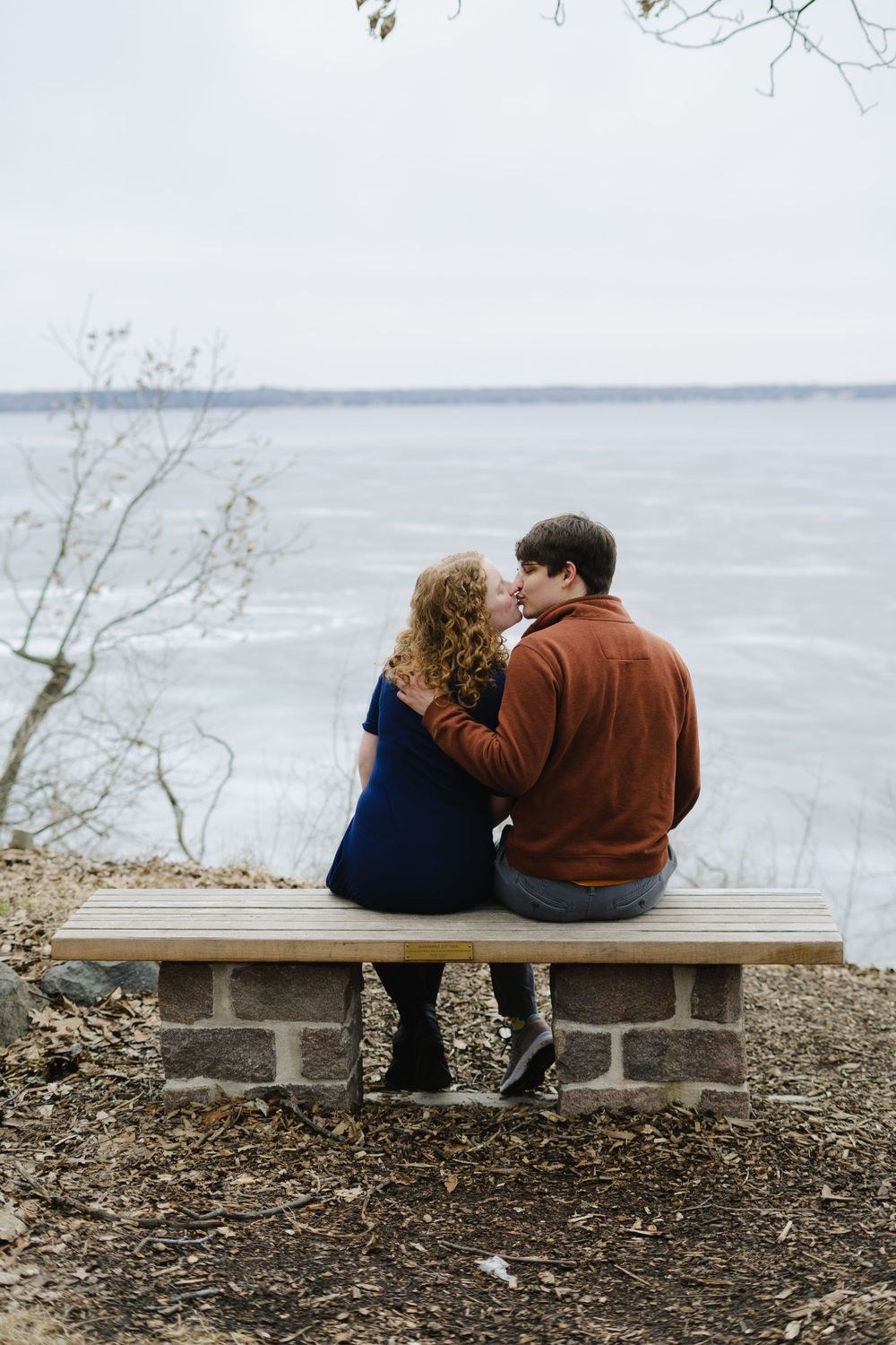 kissing with the icy lake mendota in the background - couple photography in madison wisconsin