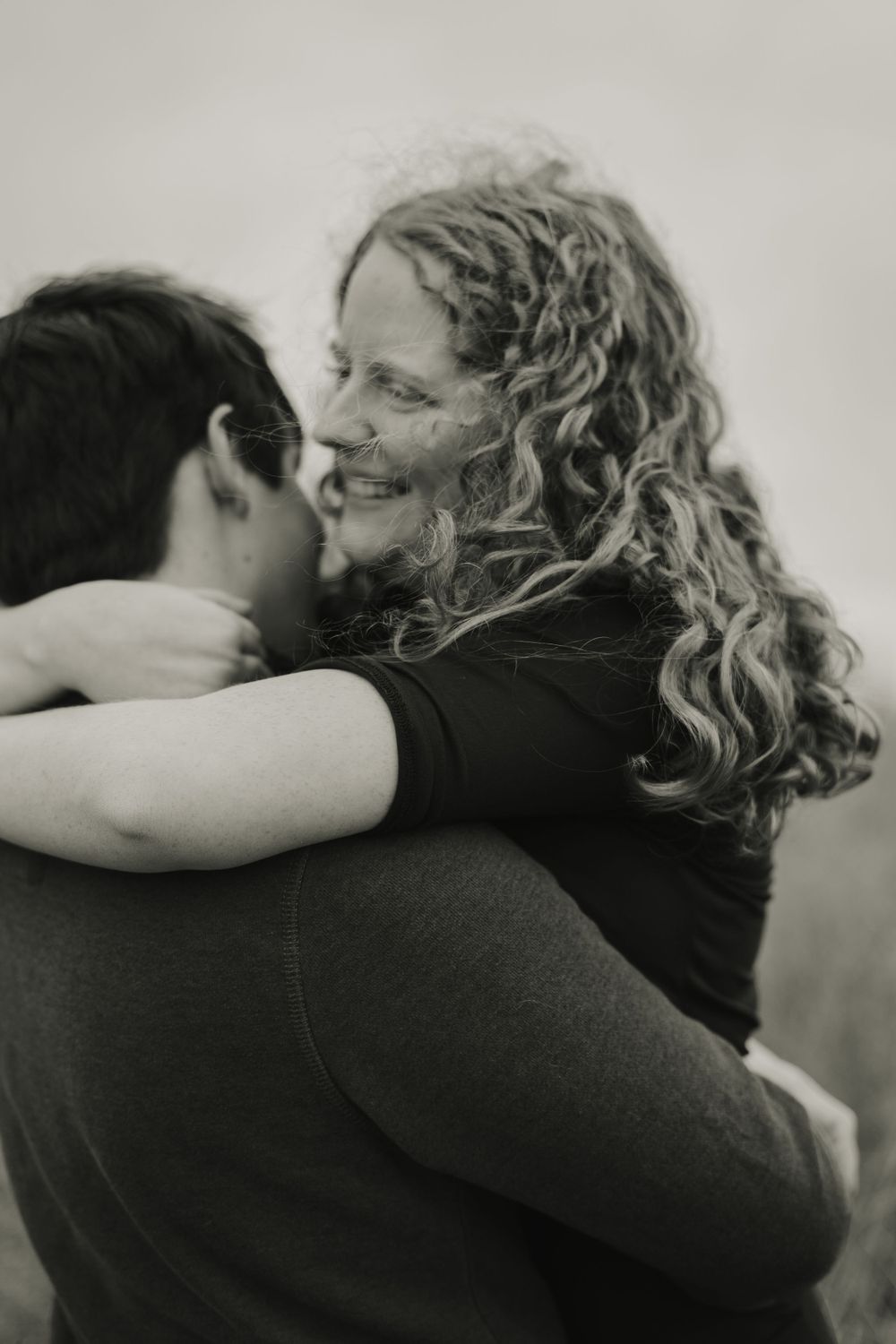 jake lifting emily and spinning her - couple photography in madison wisconsin