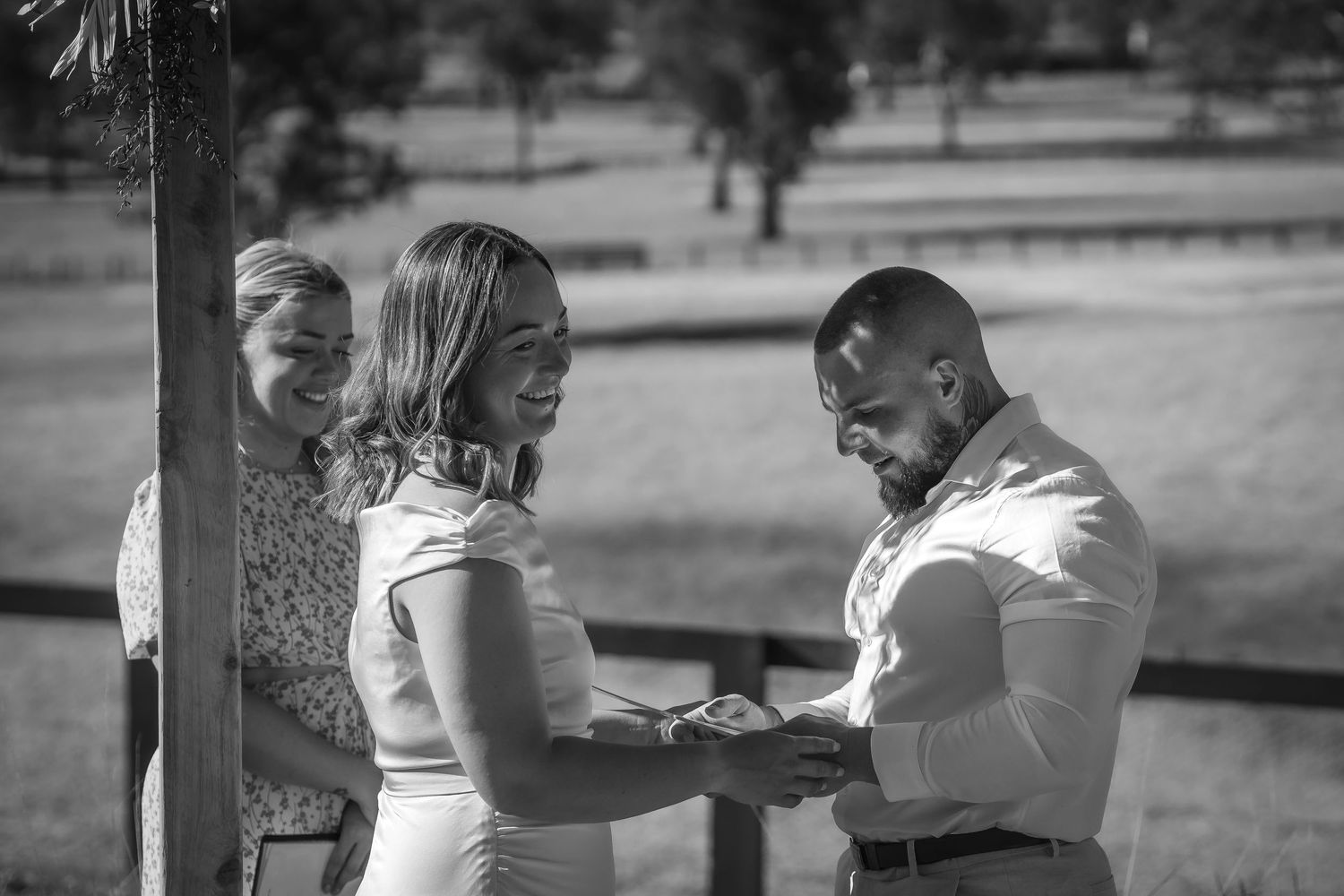 Black and white intimate moments captured during an outdoor wedding celebration.