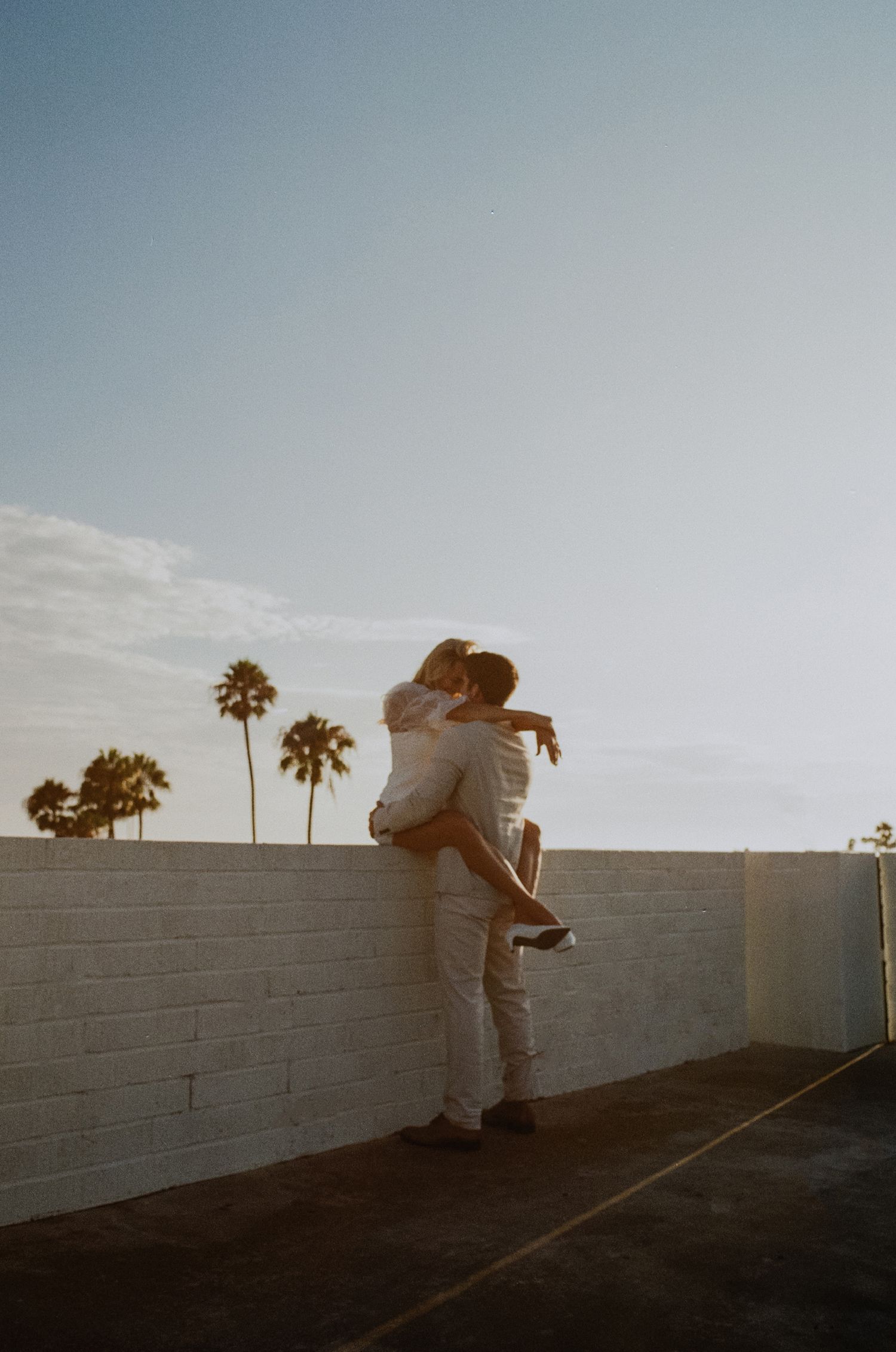 35mm film photo of fun bridal themed engagement shoot on roof of parking structure in Lido Marina, Newport beach
