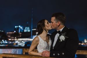 Bride and groom photos at night along the Halifax Boardwalk in Downtown Halifax, Nova Scotia