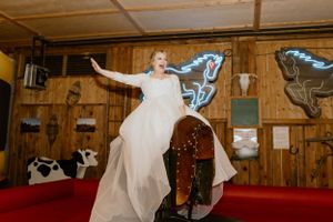 Bride Emma riding mechanical bull at Hatfield Farms, Hammonds Plains, Nova Scotia