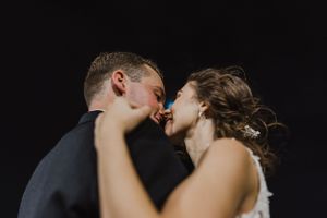 Bride and groom photos at night along the Halifax Boardwalk in Downtown Halifax, Nova Scotia