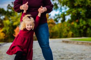 A girl plays with her mom