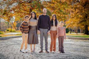 breathtaking colorful clear family standing together on cobblestones