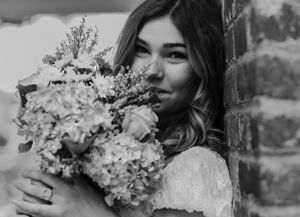 Taker your breath away stunning black and white image of a girl with a bouquet of flowers