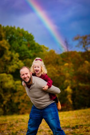 Wow, a rainbow is the perfect backdrop for this father and daughter