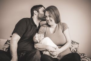 A sweet new family shares a sweet embrace