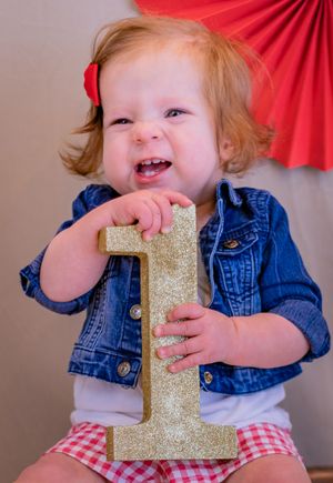 An adorable girl ready to party celebrates her first birthday