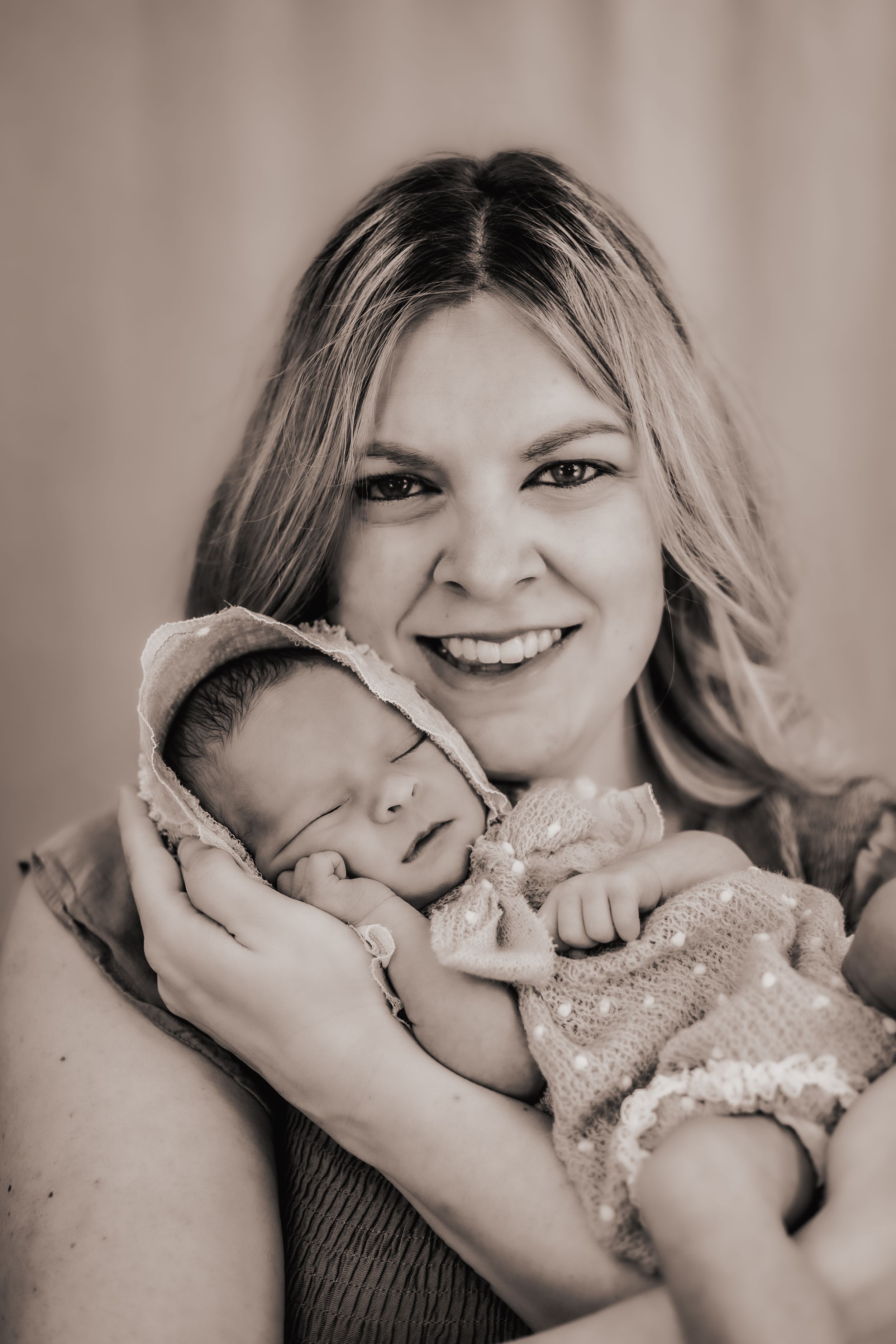 a beautiful portrait of a mother cradling her sleeping baby