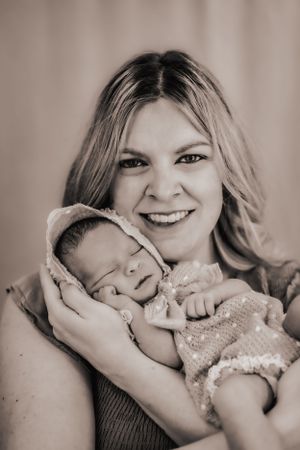 a beautiful portrait of a mother cradling her sleeping baby
