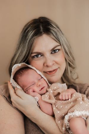 a beautiful portrait of a mother cradling her sleeping baby