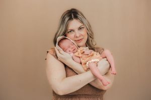 a beautiful portrait of a mother cradling her sleeping baby