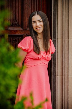 a girl smiles for her senior portrait.  Vibrant and crisp colods