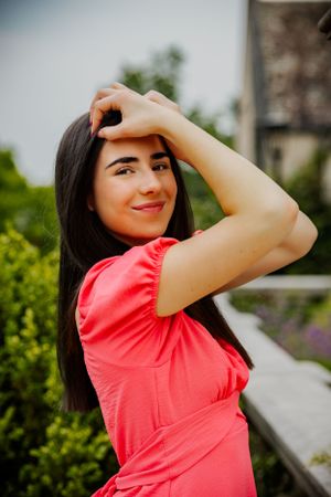 a beautiful senior portrait of a senior framing her face