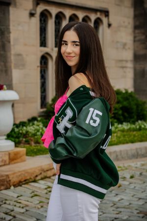a girl shows off her letterman jacket