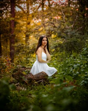 striking and beautiful natural senior portrait in the woods with vibrant colors and golden light