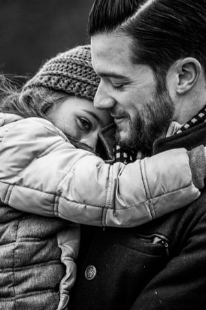 a father comforts his daughter in the cold