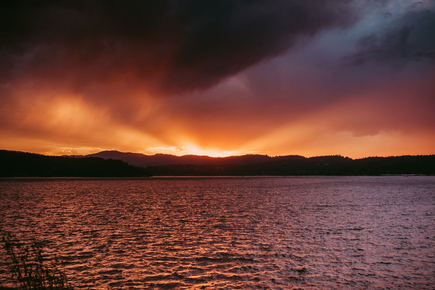 Sunset at coeur d'alene, Idaho with the lake and far off mountains.