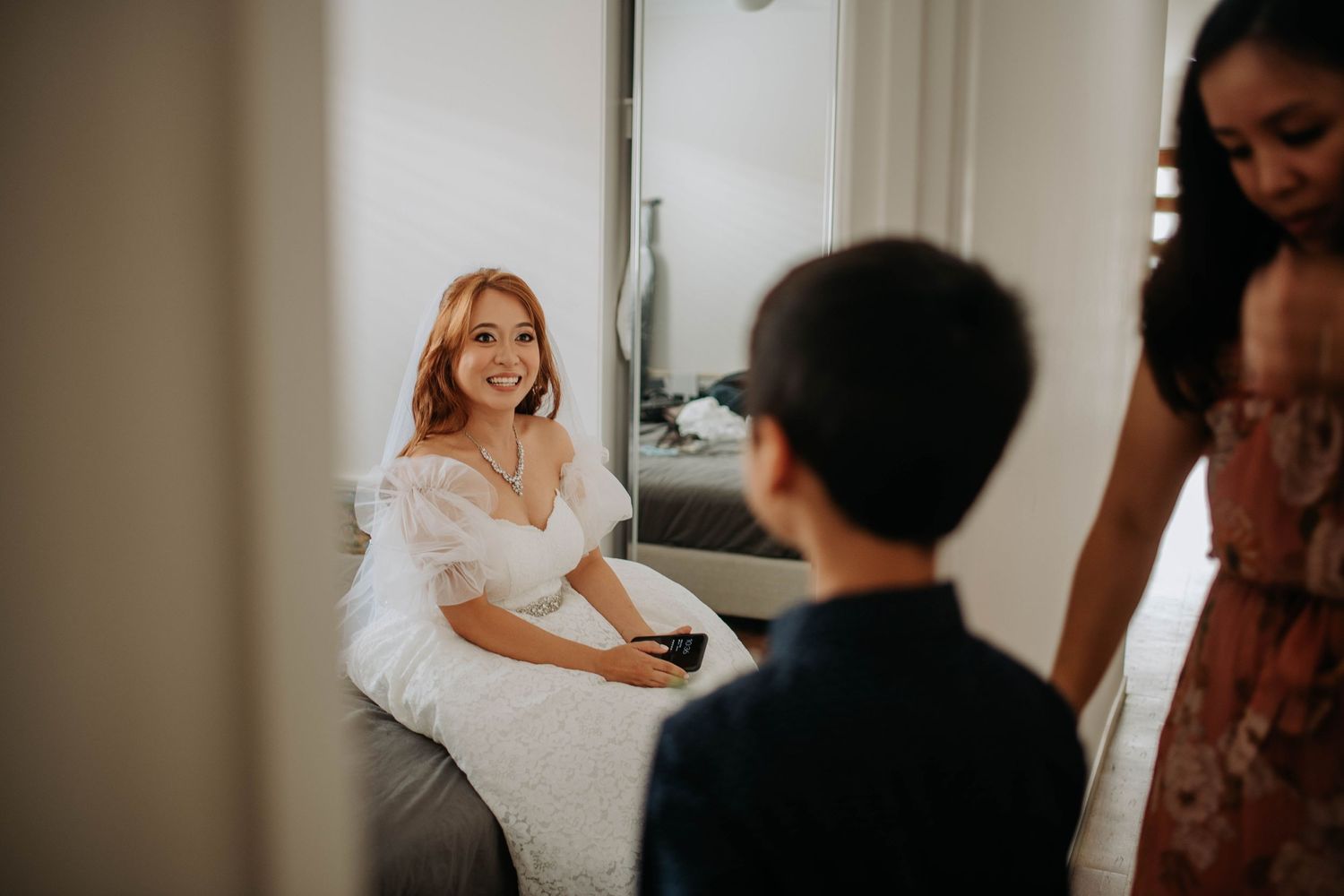 Wedding preparation scene with white dress and natural lighting.