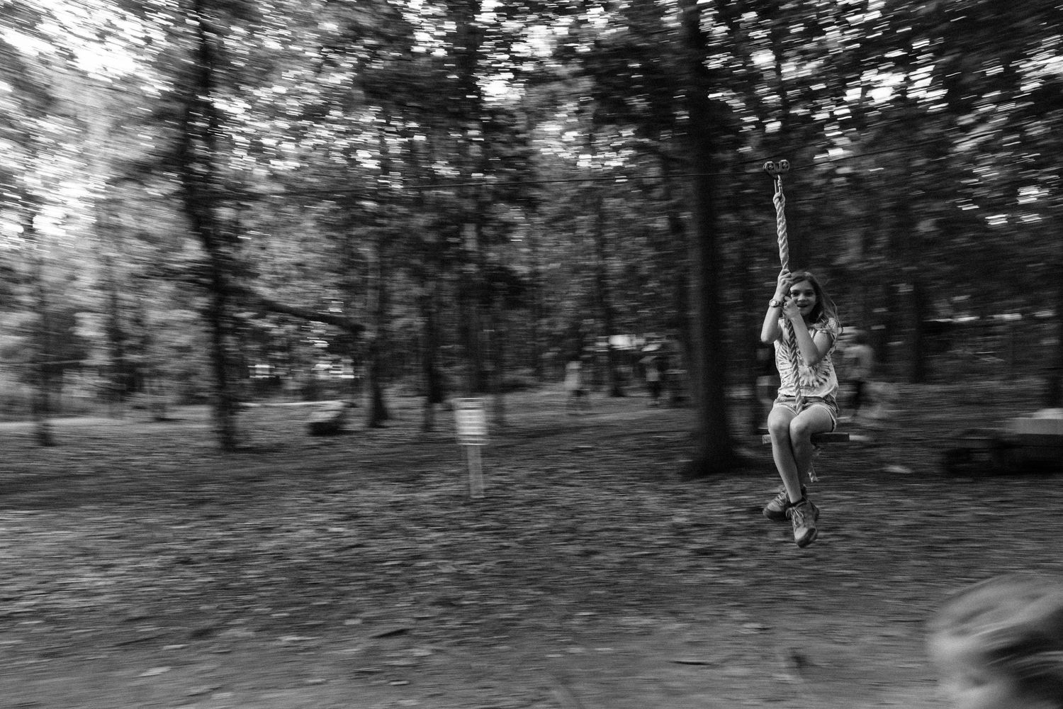 Panning image of girl on play equipment at Wise Acres