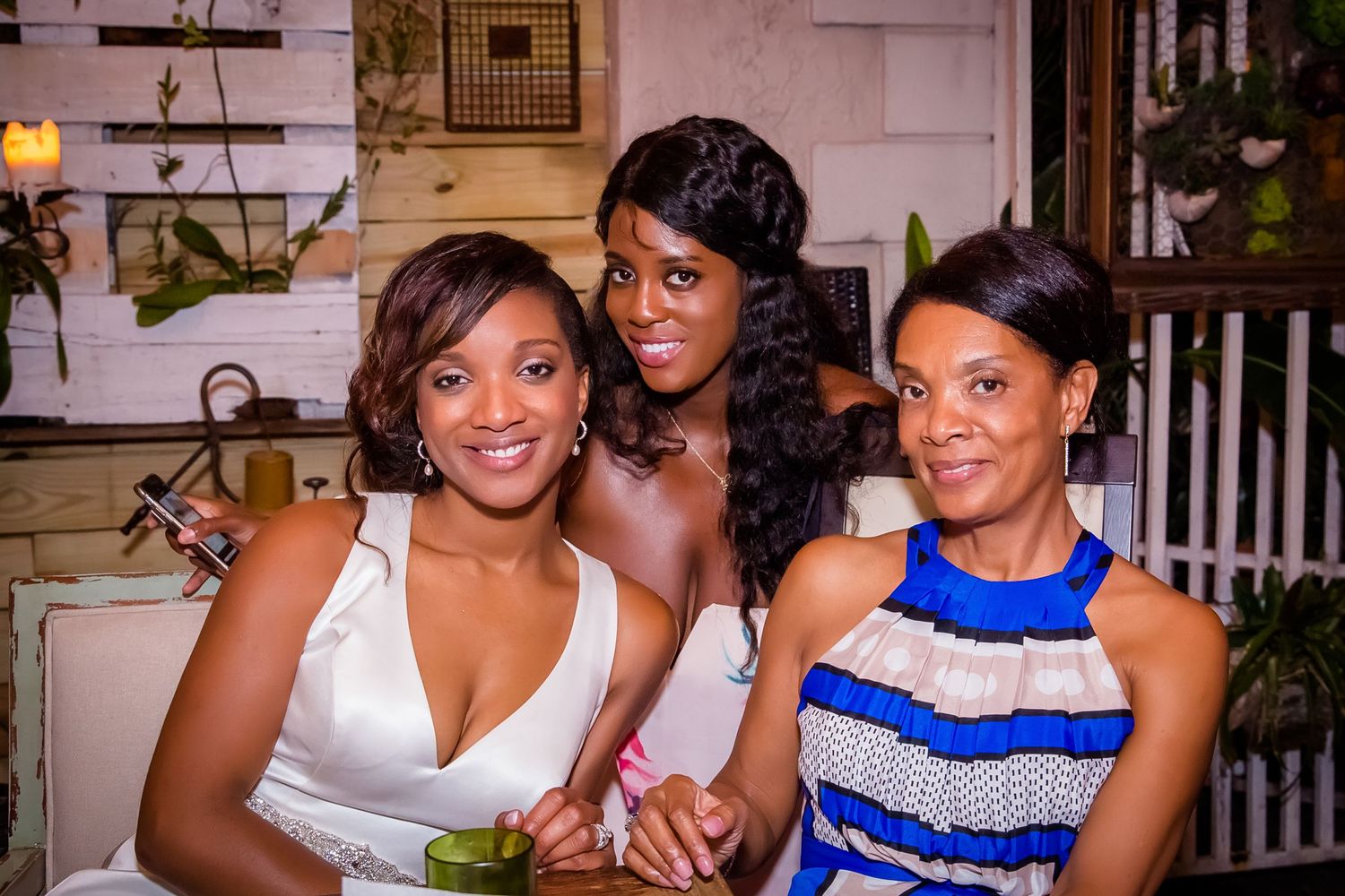 Wedding party members posing together in coordinated blue and white formal attire.