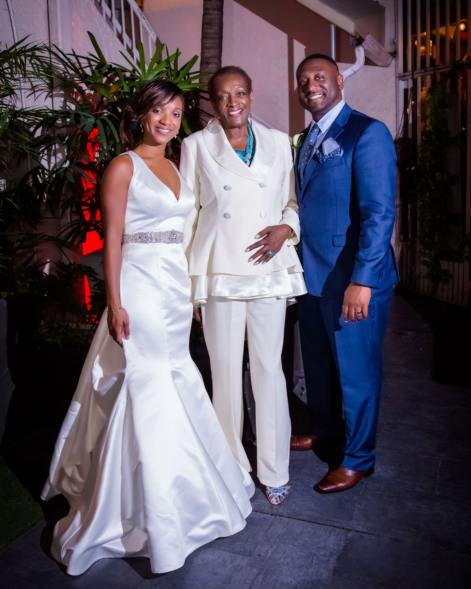 Wedding celebration in a decorated indoor venue with formal attire.