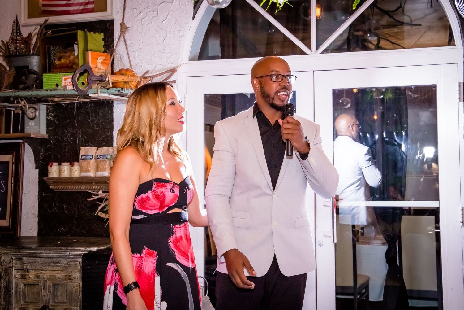 Wedding guests enjoying a celebration at a rustic venue with warm lighting and elegant decor.