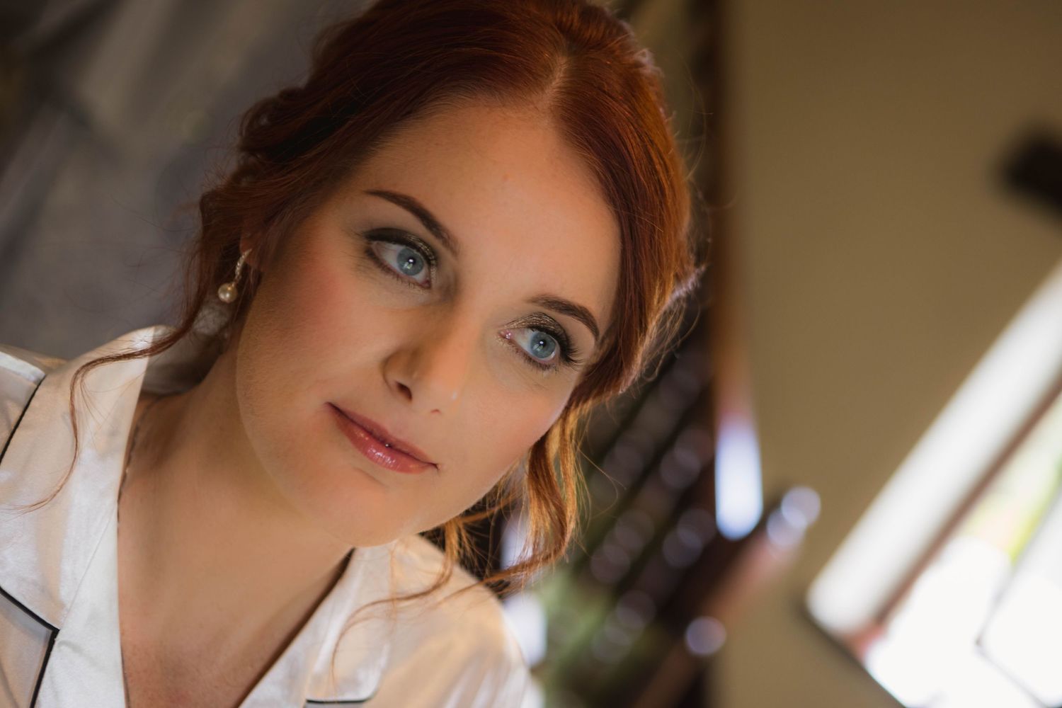Artistic portrait in soft natural light captures romantic wedding day moment.