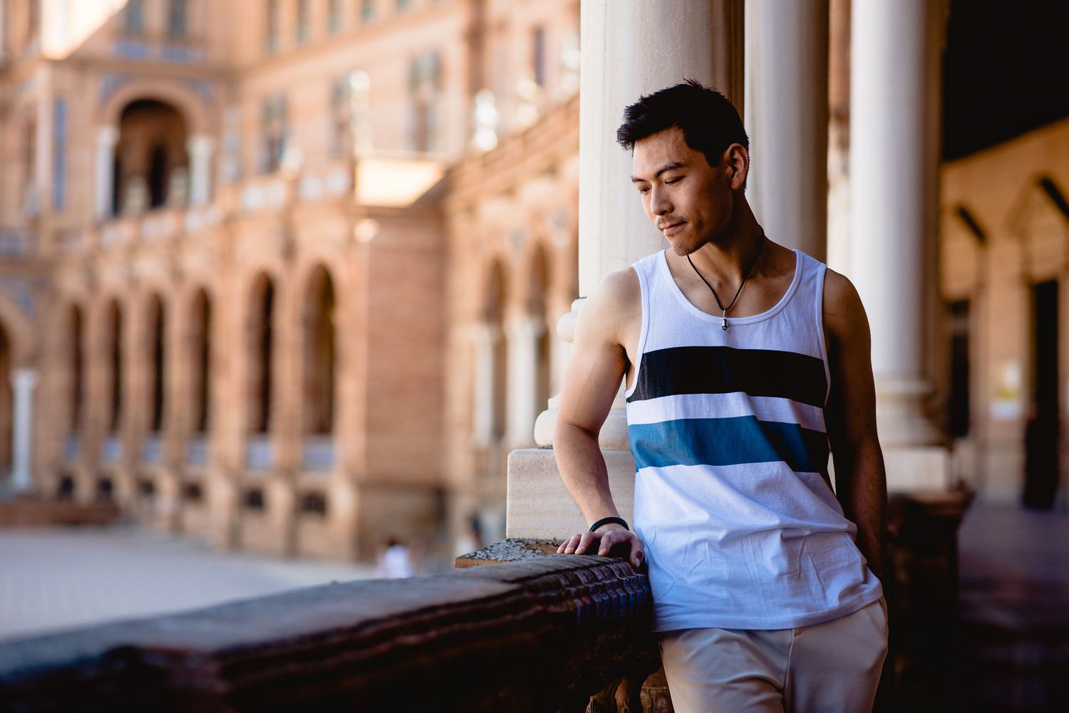 White and blue striped tank top against classic Spanish colonial architecture.