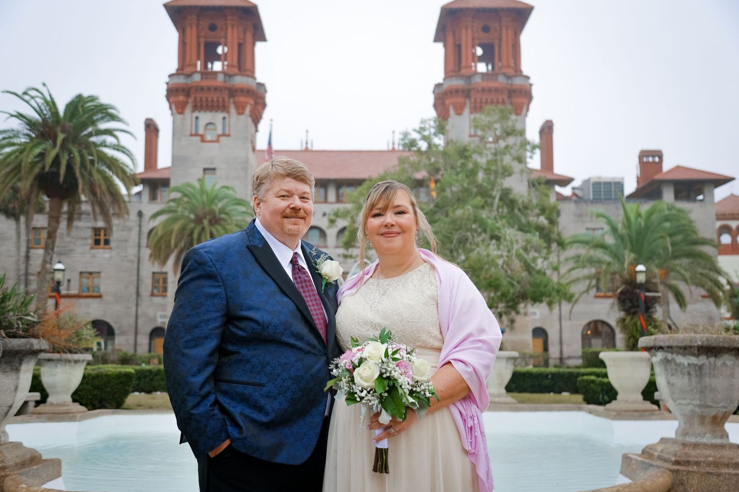 A wedding couple poses in front of the historic Lightner Museum with its Spanish Renaissance architecture.